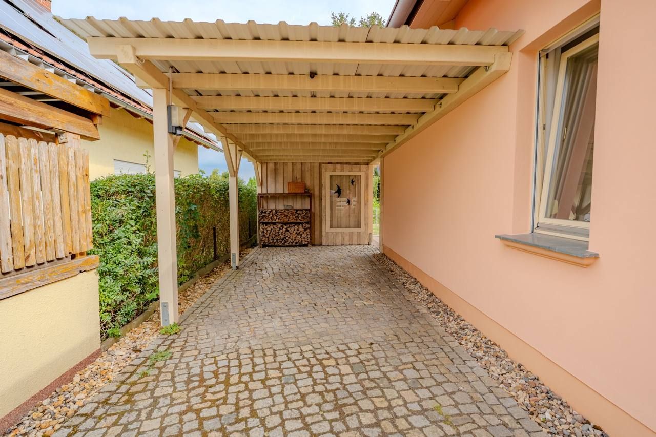 Ebenerdiger Bungalow mit Kamin, 2009 – Carport mit Holzlager und Abstellraum